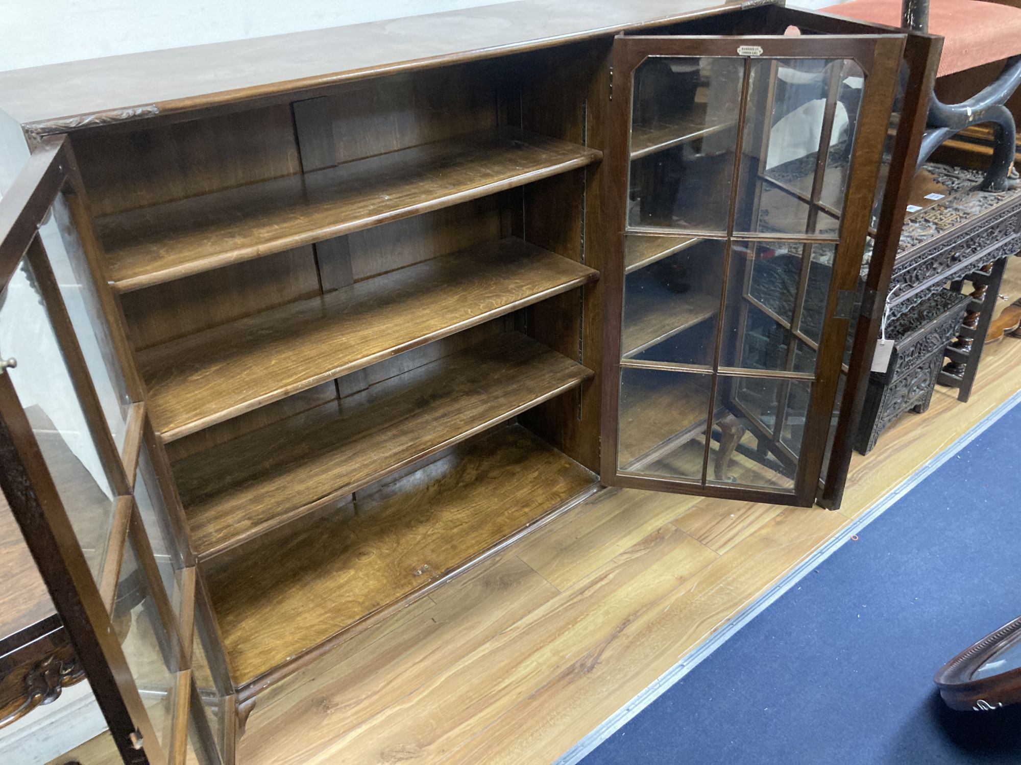 A Queen Anne revival burr walnut three door glazed bookcase, width 132cm, depth 33cm, height 118cm